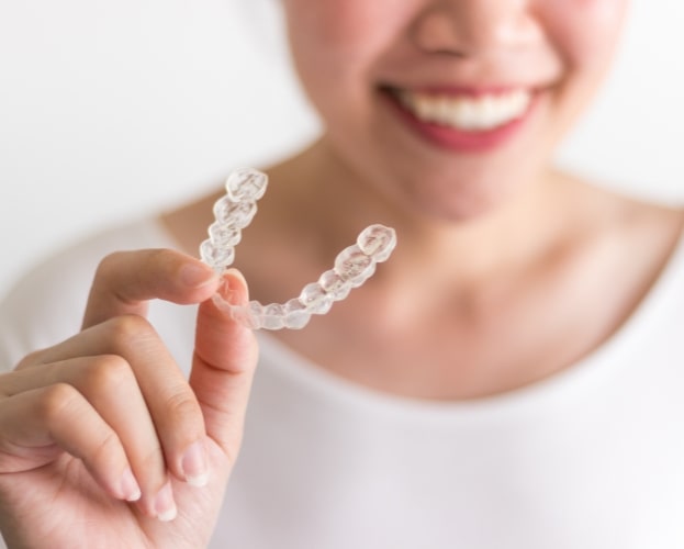 Person holding an Invisalign tray