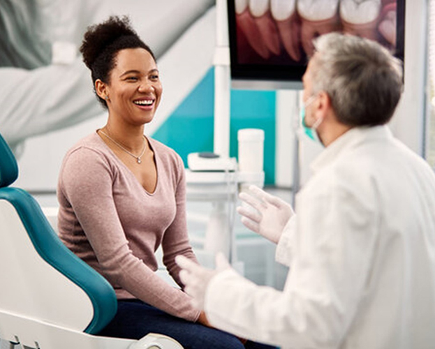 a closeup of a patient smiling at their dentist 