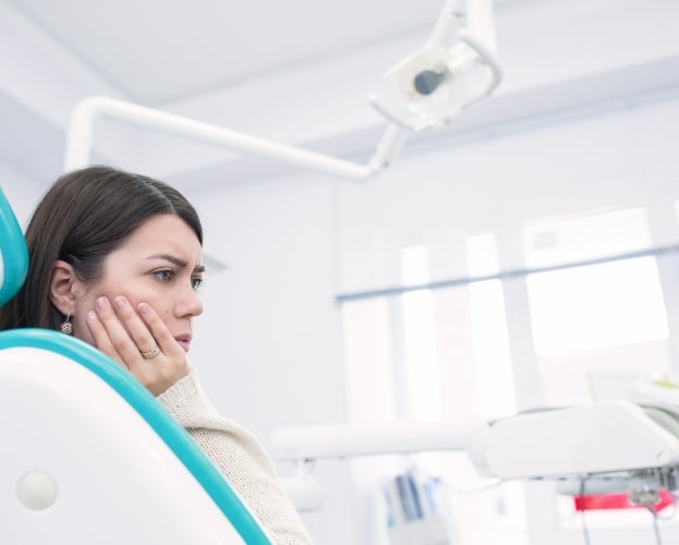 Woman discussing the cost of treating dental emergencies