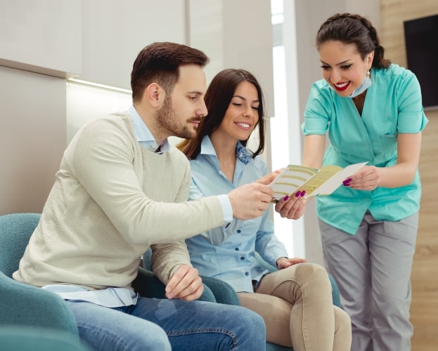 Dental patients and team member discussing what dental insurance plans cover