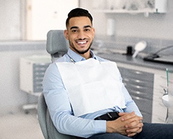 Man smiling while sitting in dentist's treatment chair