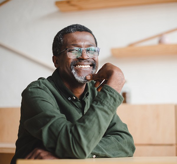 Man smiling after replacing missing teeth