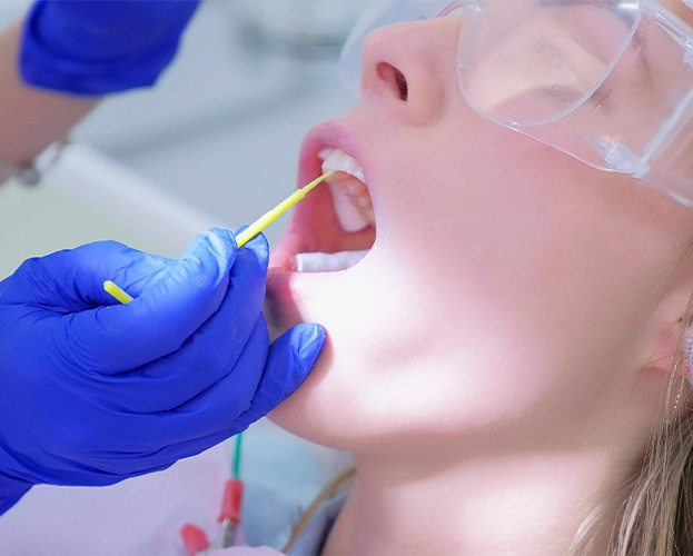 Dental patient receiving fluoride treatment