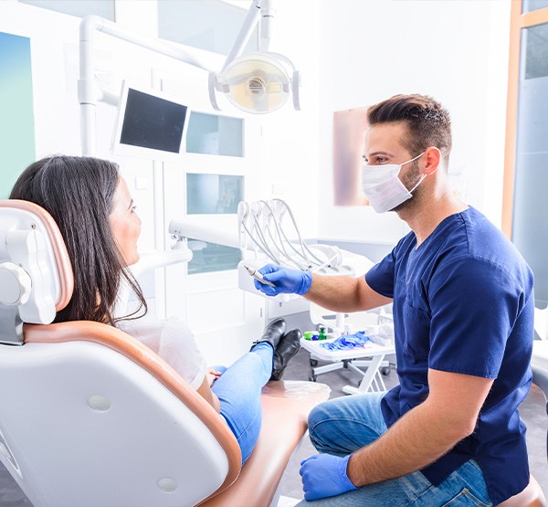 Dentist talking to patient during preventive dentistry visit