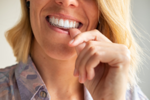 a patient holding their Invisalign aligner
